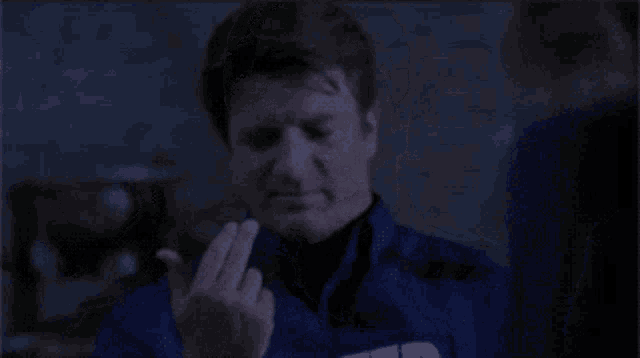 a man wearing a blue jacket with the letter s on it