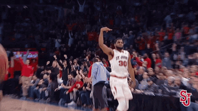 a basketball player with the number 30 on his jersey celebrates