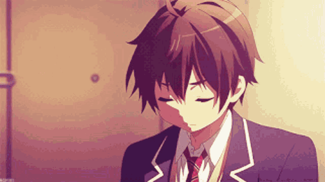 a boy in a suit and tie is looking down