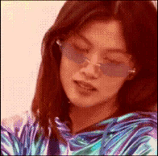a close up of a woman wearing sunglasses and a striped shirt