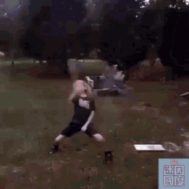 a young boy is playing with fireworks in a park