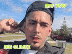 a man wearing a hat with big ysw and big slimee written on the bottom