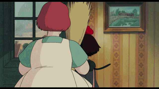 a woman with red hair is standing in front of a picture
