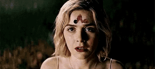 a close up of a woman 's face with a white glow on her face .