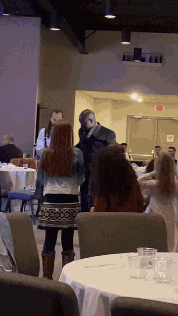 a group of people sitting at tables in a room