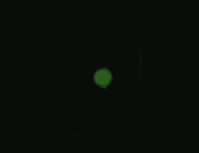 a green light is shining from the top of a robot .