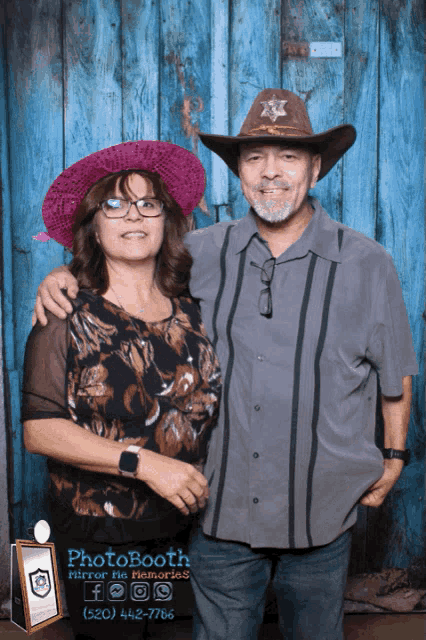 a man and woman pose for a photo in front of a photo booth that says photo booth mirror his memories