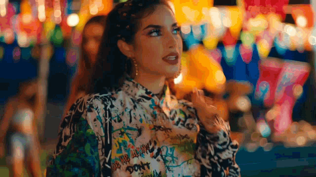 a woman wearing a colorful shirt that says do n't worry