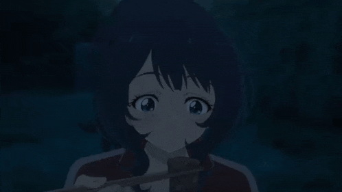 a young girl is eating a piece of meat with chopsticks .
