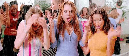 a group of young women are standing in the rain .