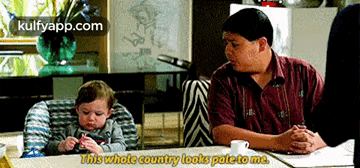 a man sits at a table with a baby in a high chair and says this whole country looks pale to me .