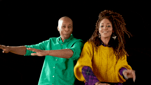 a man in a green shirt and a woman in a yellow sweater are standing next to each other
