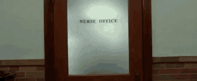 a glass door with the words `` nurse office '' on it .