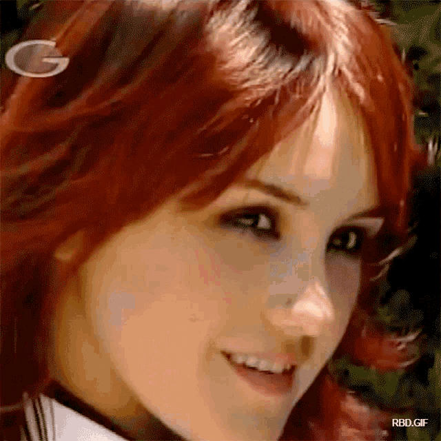 a close up of a woman 's face with a g on the bottom