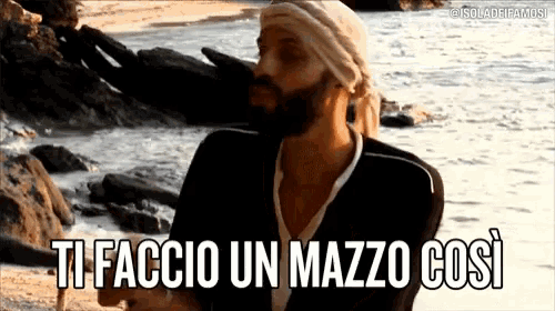 a man with a beard and a head scarf says ti faccio un mazzo cosi