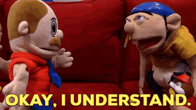 two stuffed animals are sitting on a red couch and one of them is smoking a cigarette .