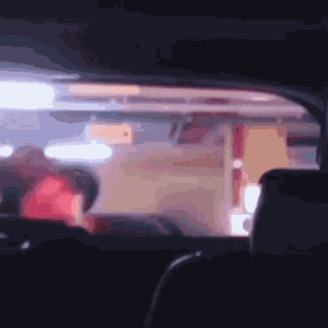 a blurry picture of a car window with a sign that says ' x ' on it