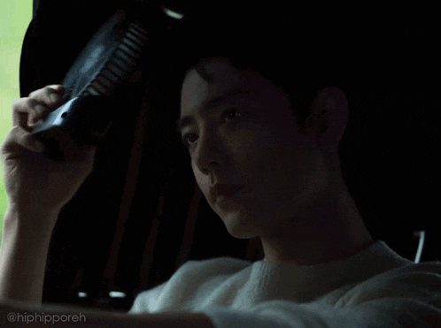 a man in a white sweater is holding a fan in his hand with the caption hiphipporeh