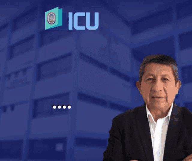 a man in a suit stands in front of a sign that says icu