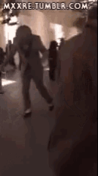 a group of people are standing in a room with the website mxxxre.tumblr.com visible