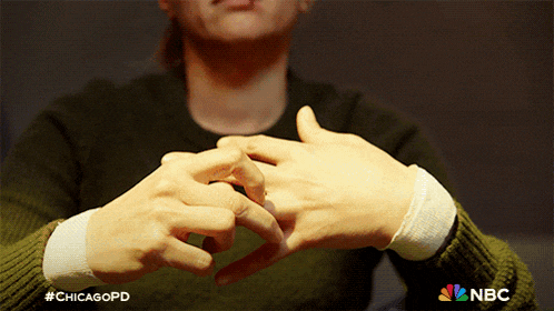 a close up of a person 's hands with the nbc logo visible