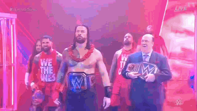 a group of men standing next to each other on a stage wearing shirts that say `` we the ones '' .
