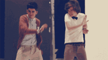 a man in a bow tie is dancing with another man in a white shirt