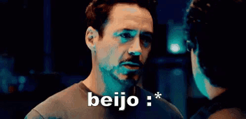a close up of a man 's face with the word beijo written above him