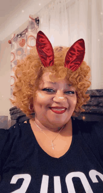 a woman wearing bunny ears and a shirt that says ' juice '