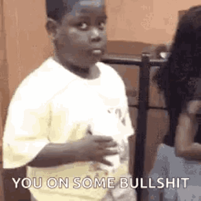 a young boy is standing in front of a woman and saying `` you on some bullshit `` .