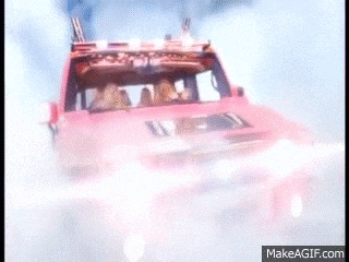 three women in a pink car with an american flag on the roof