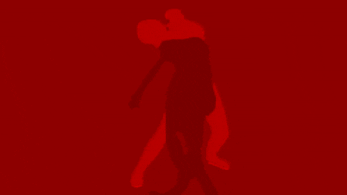 a red background with a silhouette of a person dancing