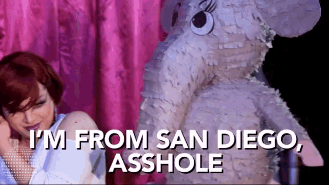 a woman is standing next to a stuffed elephant and says i 'm from san diego asshole