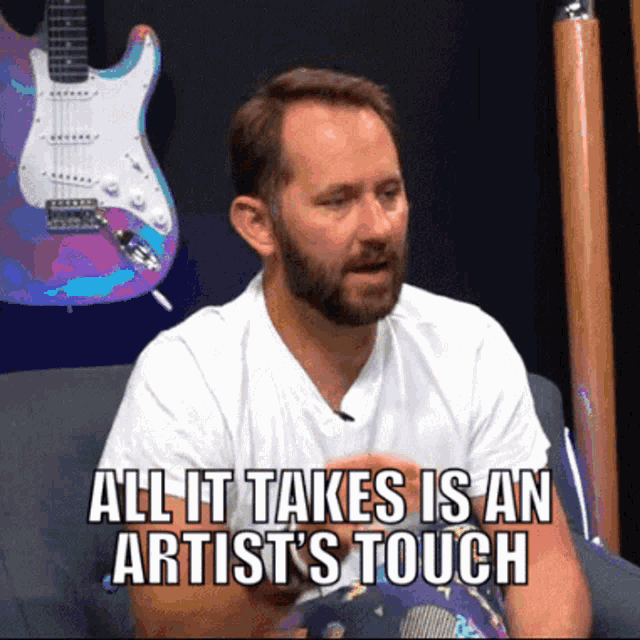a man with a beard says all it takes is an artist 's touch while sitting on a couch