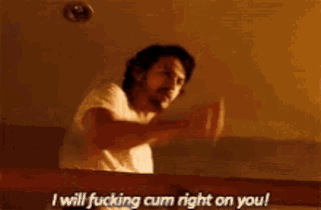 a man is giving the middle finger and says `` i will fucking cum right on you ! ''