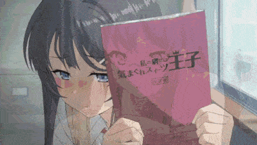 a girl is reading a book with foreign writing on it