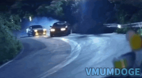 a blurred image of cars driving down a road with the words vmumdoge in the corner