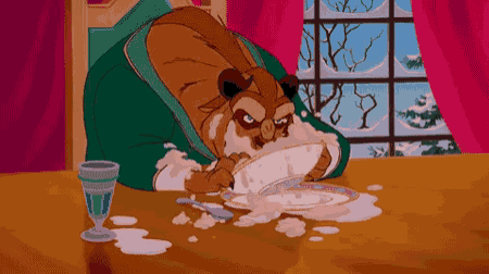 a cartoon of a beast eating a plate of food on a table