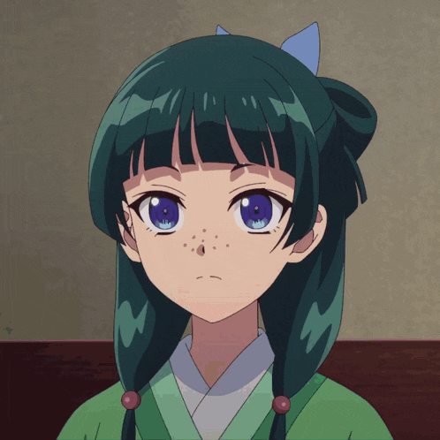 a girl with green hair and blue eyes is wearing a green shirt