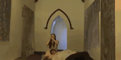 a man and a woman are standing in a room with a naked woman standing in front of them .