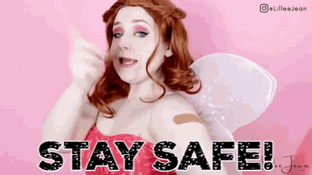a woman in a fairy costume with a bandage on her arm says stay safe