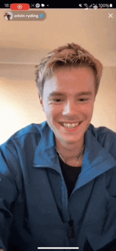 a man in a blue jacket is smiling in front of a screen that says edvin ryding
