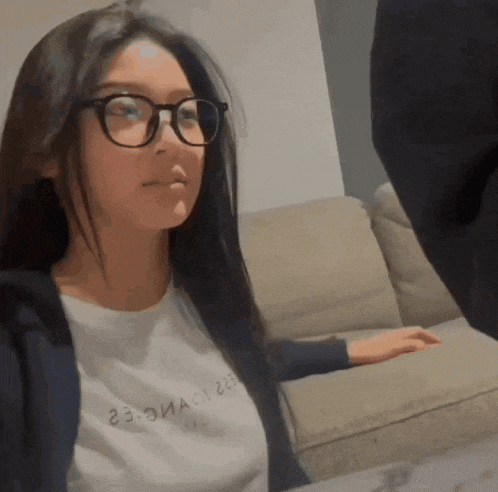 a woman wearing glasses and a t-shirt that says 23