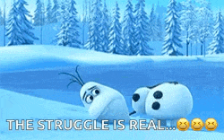 two snowmen are laying in the snow with the words `` the struggle is real '' above them .