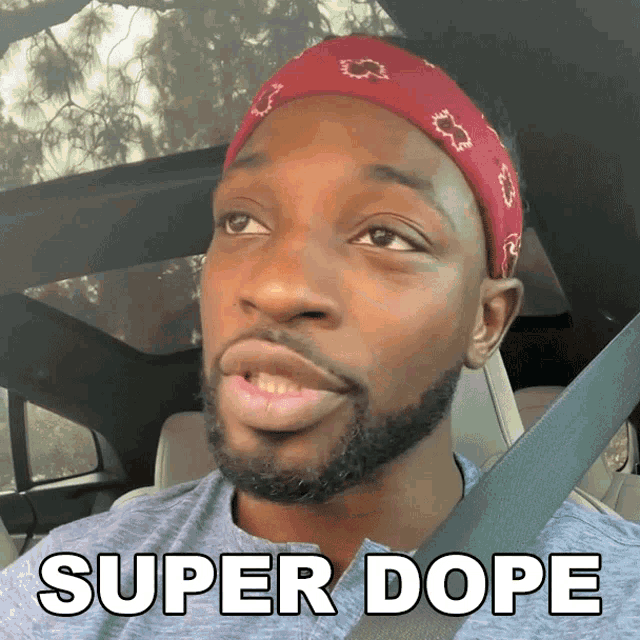 a man wearing a headband is sitting in a car with the words super dope below him