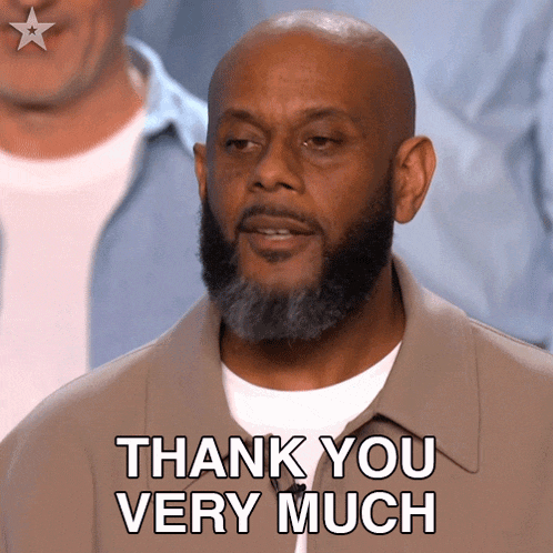 a man with a beard is giving a thank you very much sign