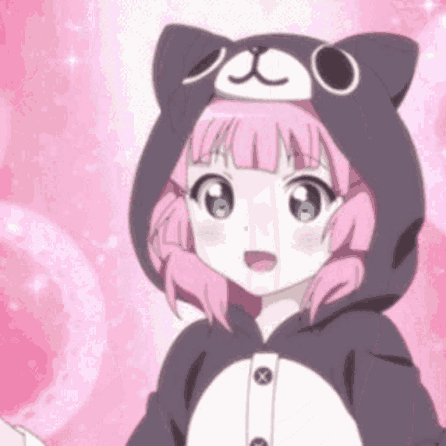 a girl with pink hair and blue eyes is wearing a cat hoodie .
