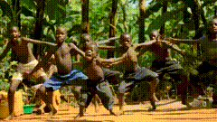 a group of young boys are dancing in a line