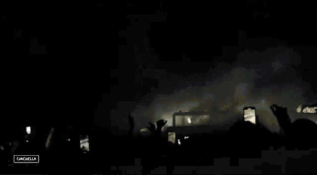 a crowd of people at a concert with the word cancella in the lower right corner