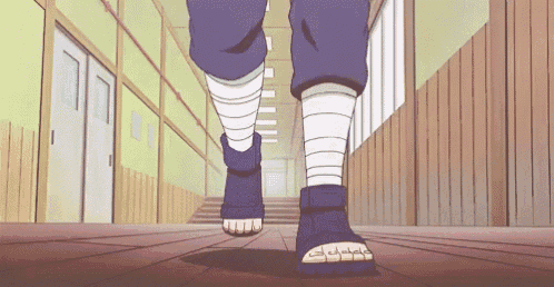a person is walking down a hallway with bandages on their legs